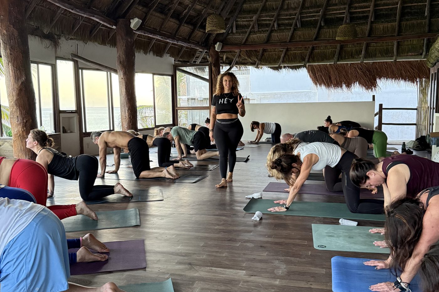 A morning yoga class in an open-air palapa above the ocean