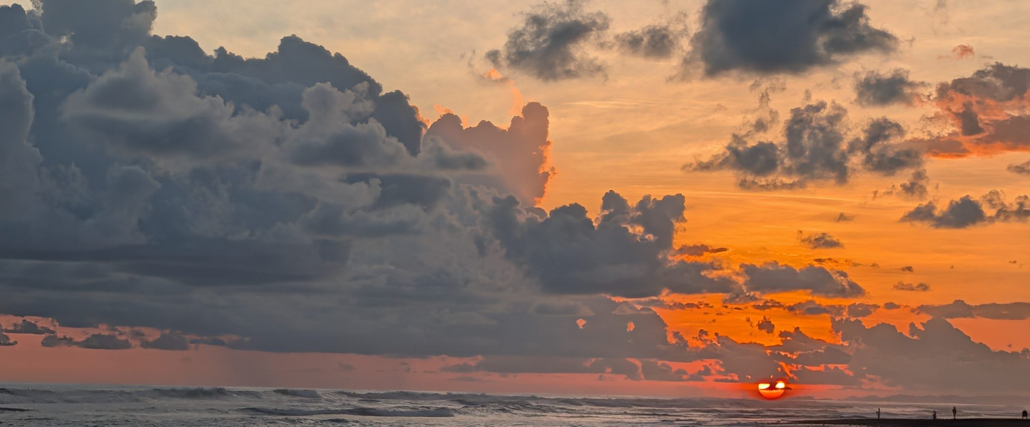 Sunset over the Pacific from the beach at Dominical, storm cloud stacked above the horizon