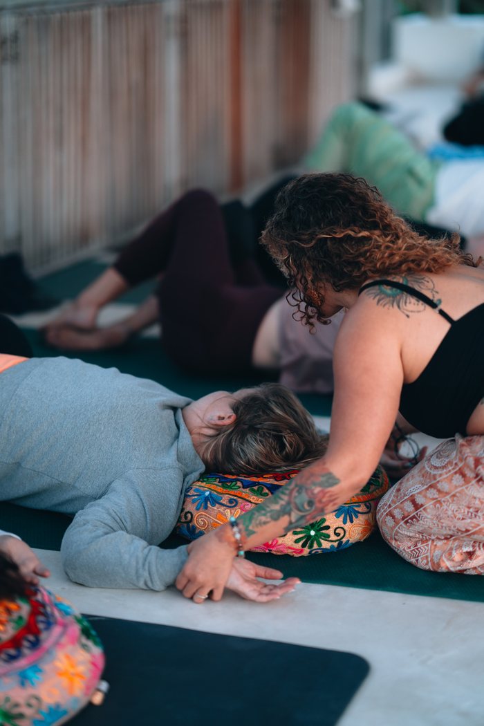 Hands resting on a client during an elemental healing session