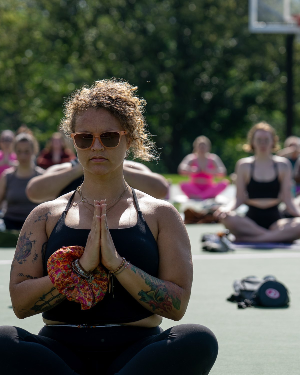 Tasha Leonard seated in an outdoor class, hands at her heart